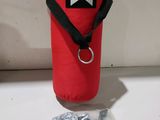 sac de voyage rouge avec une sangle noire et un anneau métallique
