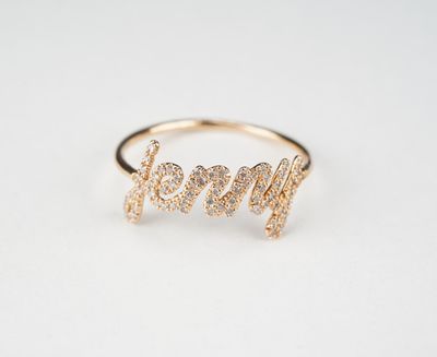 une bague en or sur laquelle est gravé le mot « maman »