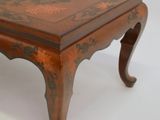 a wooden table with a floral design on it