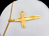 gold plated cross on a gold chain on a white mannequin