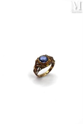 an image of a gold ring with a blue stone in the center
