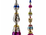 three different colored ornaments are displayed on a white surface