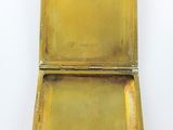 an old brass box sitting on a white surface with a white background