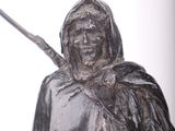 a statue of a man holding a stick in his hand