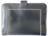 black leather wallet with white stitching on the front of it