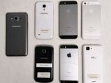 several cell phones are lined up in a row on a table