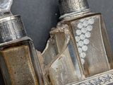 two bottles of perfume sitting on top of a silver tray
