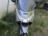 a motorcycle that is parked in the grass by a building