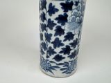 a blue and white vase with a bird on it