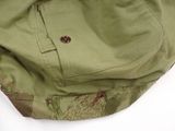a green bag with a brown button on it