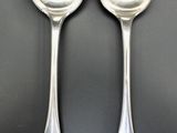 two spoons that are sitting on a table