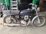 a old motorcycle that is parked in a garage