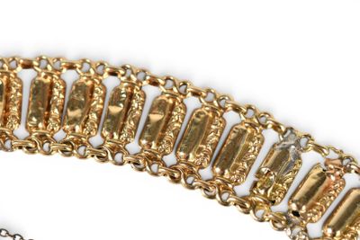 bracelet with gold and diamonds on a chain on a white surface