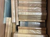 a lot of books in a box on the floor
