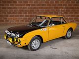 yellow and black car parked in front of a brick wall