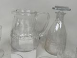 bottles and glasses are lined up on a white surface