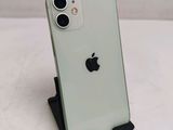a green iphone sitting on a stand on a white surface