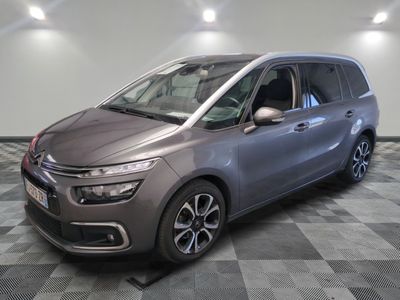 the grey citrole is parked on a checkered tile floor