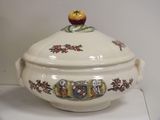 a white bowl with a lid and a coat of arms on it