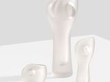 three pieces of glass sitting on a white surface