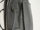 the back view of a black purse with a zipper on it