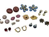 many different types of earrings and rings on a white surface