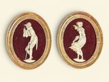 pair of gold - plated cameos depicting a man and a woman