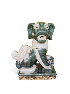 a figurine of a dog that is sitting on the ground