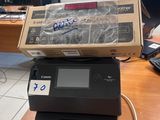 a box sitting on top of a printer on a desk