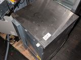 an image of a microwave oven sitting on a wooden floor