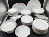 a lot of plates and bowls sitting on a table