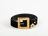 a black belt with a gold buckle and a gold buckle