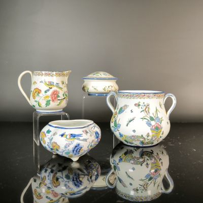 three different types of porcelain vases on a table with a mirror