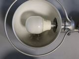 an overhead view of a bathroom sink with a toilet and a light bulb