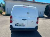 the back of a white van parked in front of a house