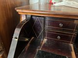 a wooden desk with a drawer on top of it