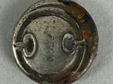 a close up of a metal button on a white surface