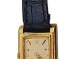 an image of a black watch with a gold band