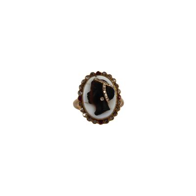 a close up of a ring with a woman ' s face on it