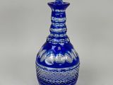 an image of a blue glass decanter on a white background