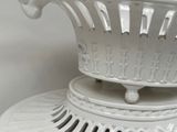 a white vase that is sitting on top of a table