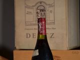 a bottle of wine sitting on a table next to a box of wine