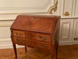 a small wooden desk with a drawer on top of it