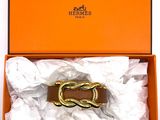 an orange box with a brown belt and a white shirt