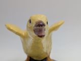 a yellow bird that is sitting on top of a table