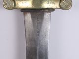 a close up of a knife on a white surface
