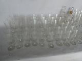 a lot of empty wine glasses sitting on a shelf