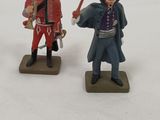 three toy soldiers that are standing in the snow