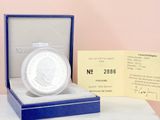 a silver coin sitting in a blue box on a table