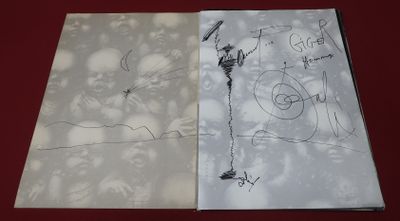 two pages of paper with drawings on them on a table
